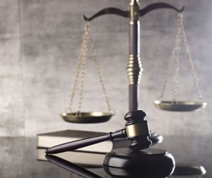 Photo of scales, gavel and a book.