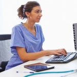 Nurse sitting at computer desk