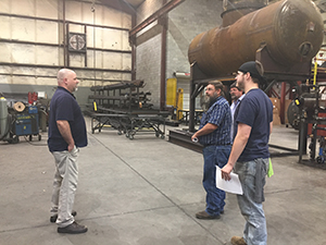 welding student on a job site with instructor and employer