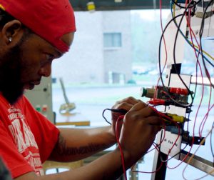 Student working on an electrical systems box