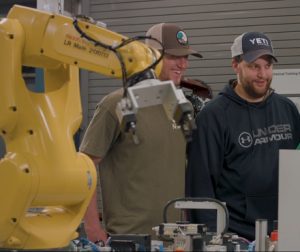 Mechatronics student watching a demonstration