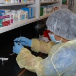 Pharmacy Student loading a syringe