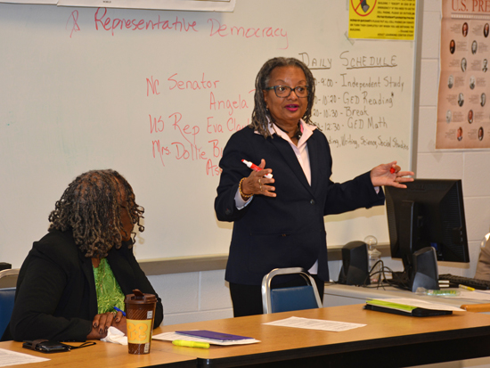 As Dollie Burwell (seated) listens, N.C. Sen. Angela Bryant discusses state government with students at VGCC. 