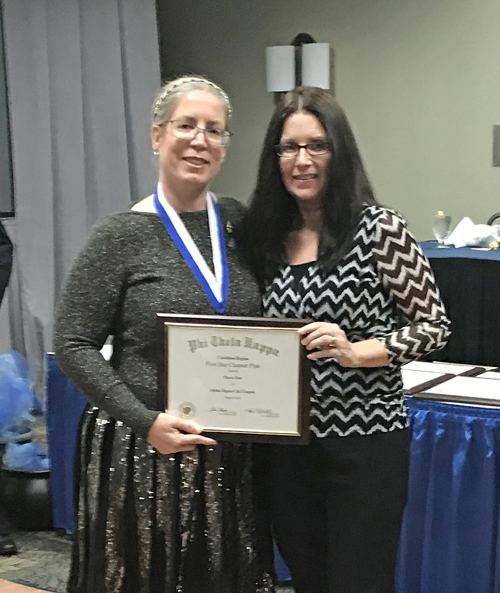 Tiffiny Wolf (left), outgoing secretary for the Carolinas Region of Phi Theta Kappa, presents an award recognizing VGCC’s chapter with “three stars” to chapter Vice President Pamela Campbell of Littleton, during the convention in Myrtle Beach, S.C. 