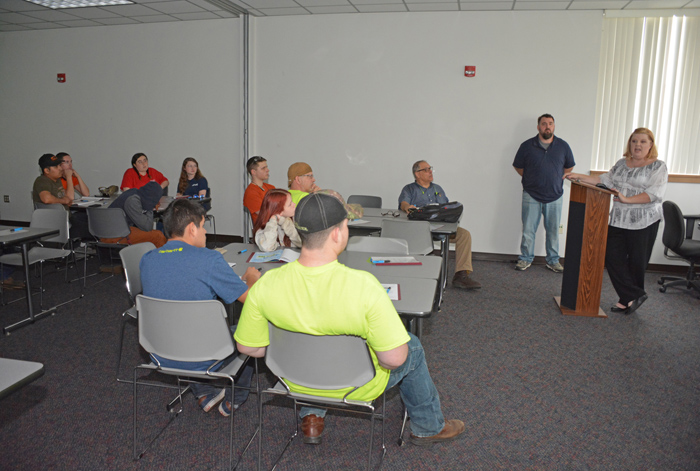 TMX Coordinator Leslie Dixon of Clayton Homes of Oxford (at podium, right) addresses VGCC Welding Technology students during a presentation on the college’s Main Campus in Vance County.