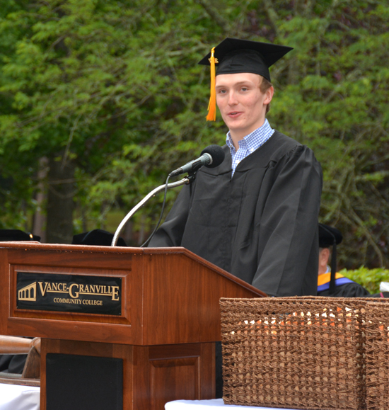 At a podium, Colton Hayes of Epsom speaks on behalf of the graduates at Vance-Granville Community College on May 12. 