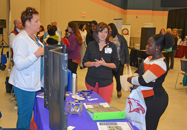 From left, Dawn Bennett and Kristin Driver, both representing Halifax Regional Medical Center in Roanoke Rapids, talk with VGCC Associate Degree Nursing student Victoria Puplampu of Durham during the Health Sciences Career Fair. 