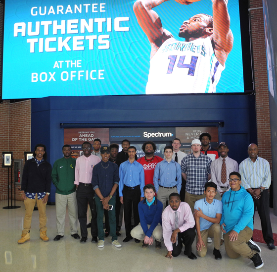 The VGCC Male Mentoring Success Initiative group poses for a picture at the Spectrum Center, home of the Charlotte Hornets. They included, kneeling from left, students Osvaldo Hernandez of Stem, Christopher Blue of Henderson, Heberito Leos of Warrenton and Travis Williams of Norlina; and standing, from left, students Thomas McCaffity of Warrenton, Christopher Pernell of Raleigh, Francis Scotland of Oxford, Antonio Adams of Raleigh, Miles Brown of Louisburg, Joseph Vodjogbe of Henderson, Niquan Cousins of Raleigh, Kendrick Pettiford of Oxford, Johnathan Williamson of Oxford, Brian Restrepo of Youngsville, William Beck of Raleigh, Hadden Justice of Louisburg, Lawrence Winston of Henderson and Darius Buford of Cary with MMSI co-coordinator Anthony M. Pope; not pictured: co-coordinator Michael Farmer. 