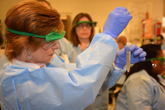 Teacher doing science experiment in a lab