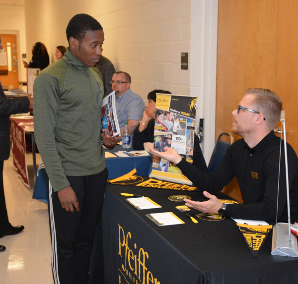 From left, Isaiah Foster, a Wake Forest High School student in the VGCC Career & College Promise (CCP) program, talks with Joshua Chasse from Pfeiffer University during College Day in Building 6 on VGCC’s Main Campus.