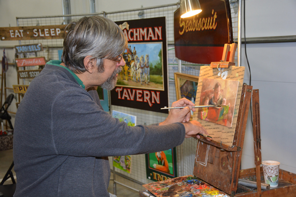 Artist Stephen Filarsky of Franklinton is seen here painting at his booth at the Handcrafted Holiday Market after he completed the NC REAL Professional Craft Artists Entrepreneurship program. (VGCC photo)