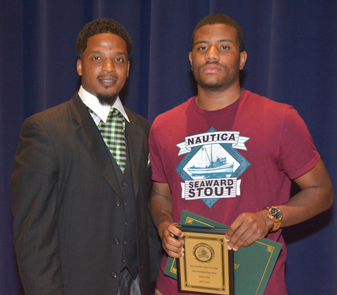 From left, VGCC Men’s Basketball Coach DeMarcus Oliver presents the Most Outstanding Player award to Raekwon Hall of Raleigh.