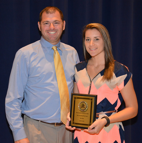 From left, VGCC Women’s Volleyball Coach Christopher Young presents the Most Outstanding Player award to Kara Reese of Henderson. 