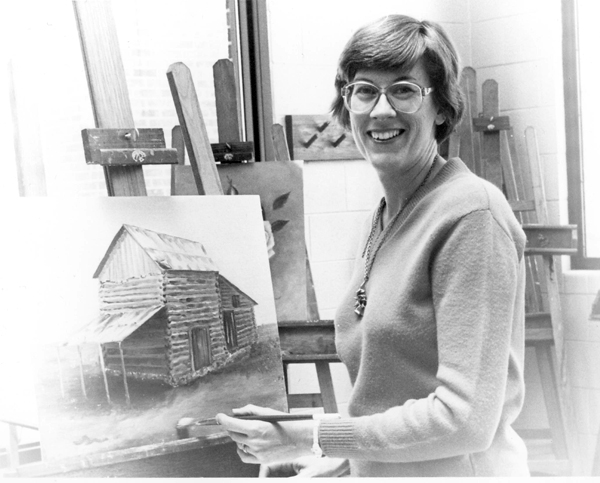 Undated black and white photo of Lelia Brigham while painting.