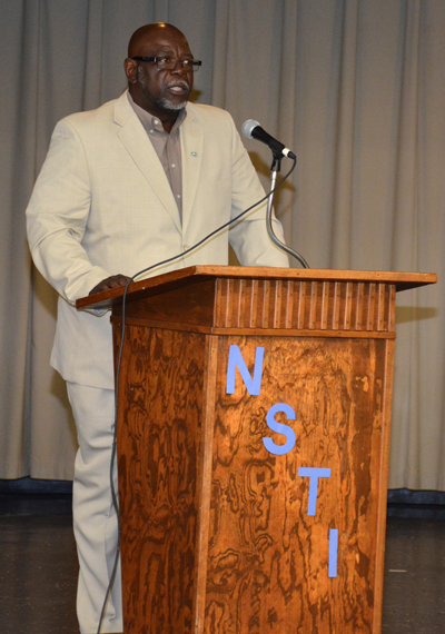 Picture of Melvin Williams speaking to NSTI graduates from a podium.