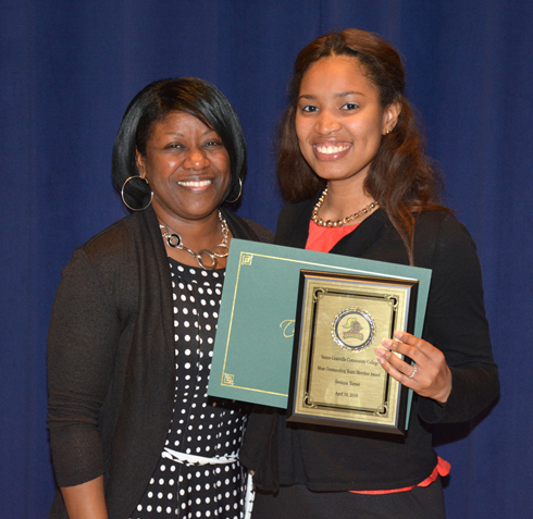 From left, VGCC Vanguard Spirit Pep Squad advisor Tina Ragland presents the Most Outstanding Team Member award to Seniqua Turner of Henderson.