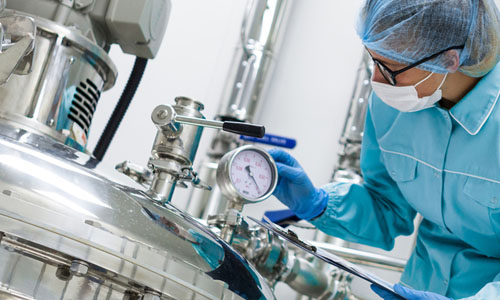 Scientists working with large vat in the lab, panoramic photo