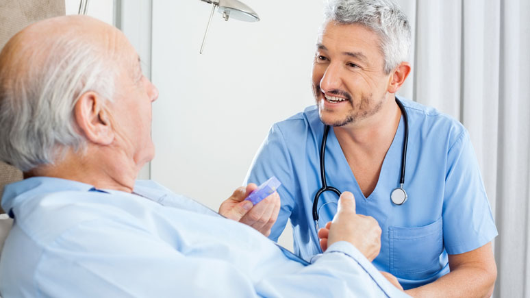 Nurse Aide dispensing medication to a patient.