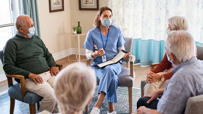 Community health worker working with a group of seniors.