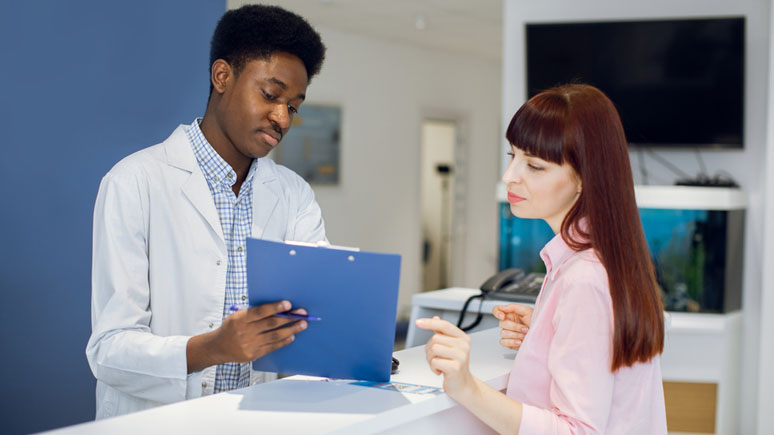 Health Unit Coordinator assisting a patient